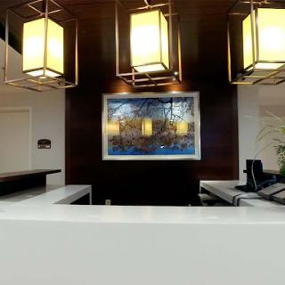 A stylish reception area featuring modern lighting and artwork.