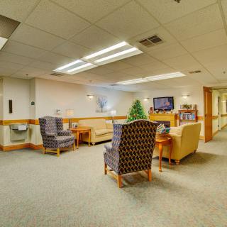 A cozy lounge area with comfortable seating and a television.