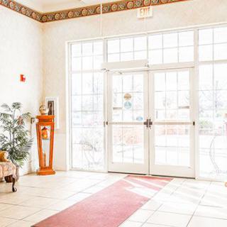 Brightly lit lobby entrance with glass doors and decorative elements.