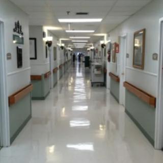 A clean and empty hospital corridor with bright lighting.