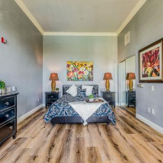 A stylishly decorated bedroom featuring modern furniture and vibrant artwork.