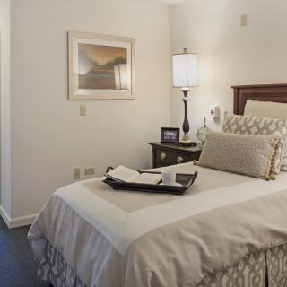 A cozy bedroom with elegant decor and soft lighting.