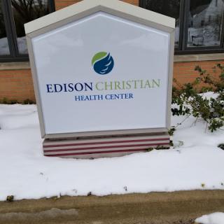 Sign of Edison Christian Health Center surrounded by snow.
