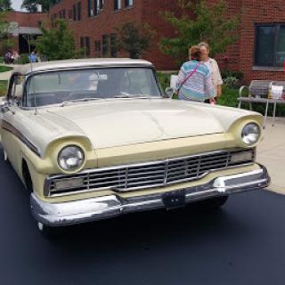 A charming vintage convertible car showcased in an outdoor setting.