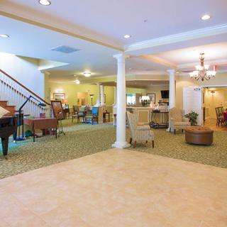 A spacious and well-decorated lobby area with comfortable seating and a grand piano.