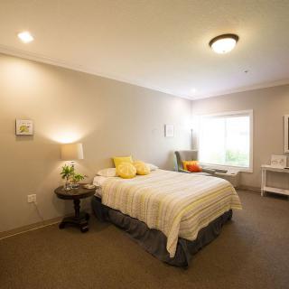 A cozy bedroom with soft lighting and simple decor.