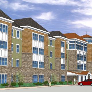 A modern multi-story apartment complex with a combination of stone and siding exterior.