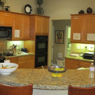 A modern kitchen with wooden cabinets and a granite countertop.