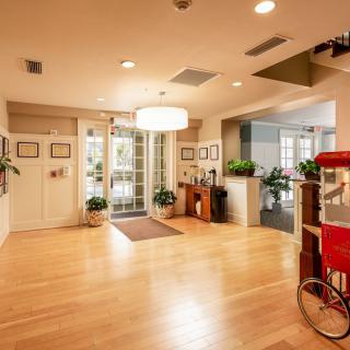 A modern lobby entrance with wood flooring, stylish lighting, and decorative plants.