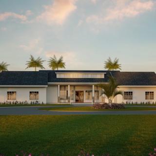 A modern house with palm trees in the sunset.