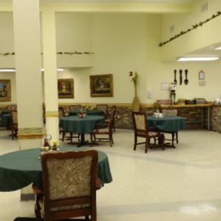 A spacious dining area with several tables and chairs arranged for guests.
