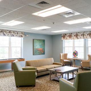 A comfortable living room with modern furniture and large windows.