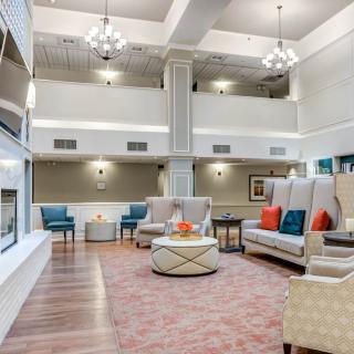 A spacious modern lounge with comfortable seating and elegant decor.