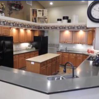 A spacious kitchen with wooden cabinets, a central island, and modern appliances.