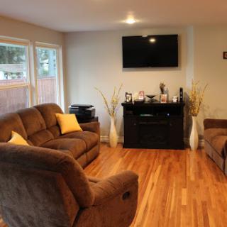 A cozy living room featuring a comfortable sofa, a wall-mounted TV, and elegant decor.