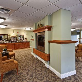 A comfortable lobby and reception area with seating and a fireplace.