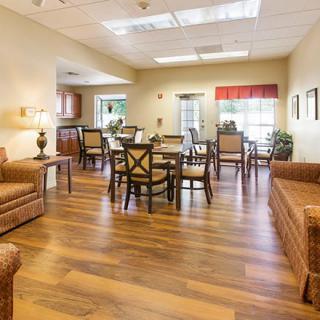 A cozy living and dining area with wooden flooring and comfortable furniture.