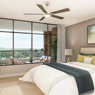 A modern bedroom with large windows, featuring neutral tones and a ceiling fan.
