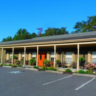 A single-story motel with a front parking area.