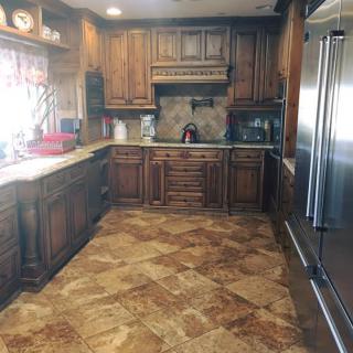 A traditional kitchen with wooden cabinets and stainless steel appliances.