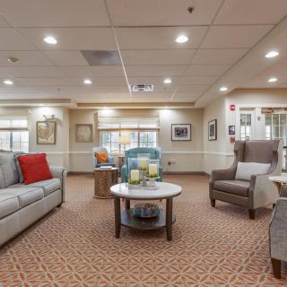 A cozy living room with comfortable seating and warm lighting.