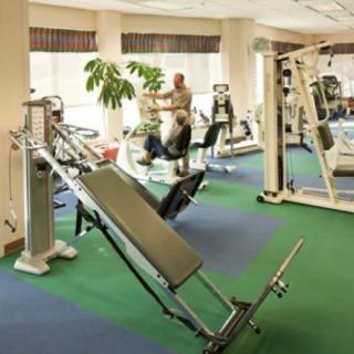 A well-equipped gym with various exercise machines and workout stations.