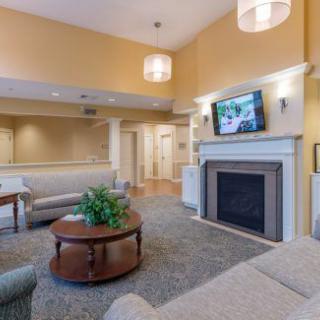A cozy living room with a sofa, fireplace, and television.