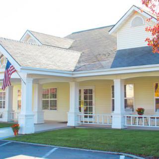 A charming residential house with a porch and an American flag.