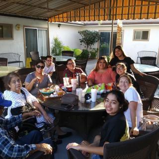 A family enjoying a meal together outdoors.