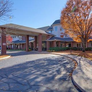 A picturesque view of a building entrance surrounded by autumn trees.