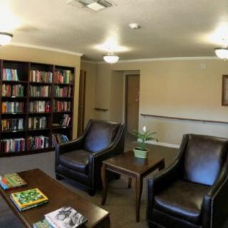 A cozy reading room with bookshelves and comfortable seating.
