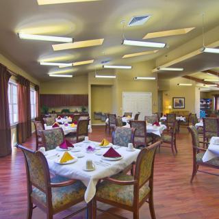 An elegantly decorated dining room with neatly arranged tables and chairs.
