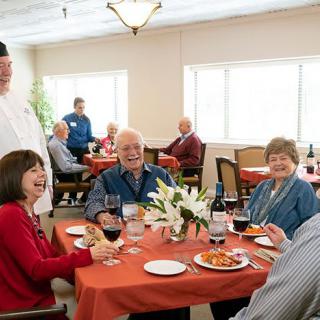 A group of seniors enjoying a meal together in a restaurant setting.