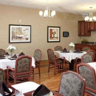 A cozy dining room with elegantly set tables and comfortable chairs.