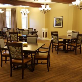 A cozy dining room with elegant furniture and warm lighting.