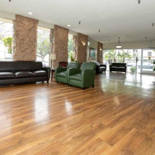 A spacious lobby area with wooden flooring and comfortable seating.