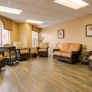 A cozy living room area with comfortable seating and ample natural light.