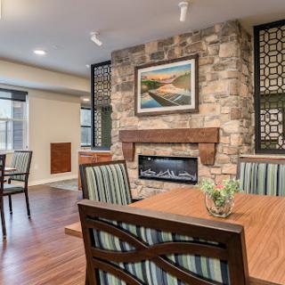 A cozy and modern living space featuring a stone fireplace and stylish dining area.