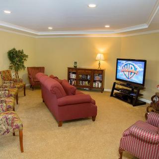 A cozy living room featuring comfortable seating and a television.