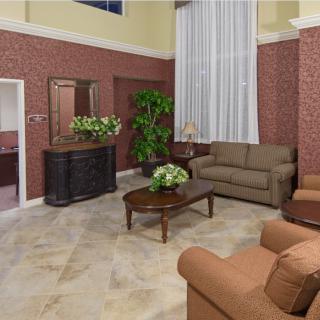 A cozy living room with elegant furniture and decorative plants.