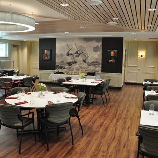 A modern restaurant dining area with neatly arranged tables and elegant decor.