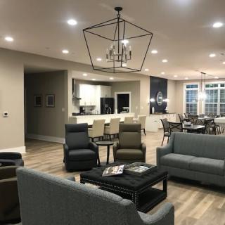 A modern open-concept living space featuring sleek furniture, a contemporary kitchen, and a stylish dining area.