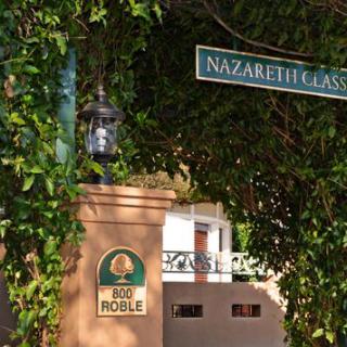 An outdoor scene showing a street sign labeled 'Nazareth Classic' next to a lamp and building entrance marked 'Old Roble'.