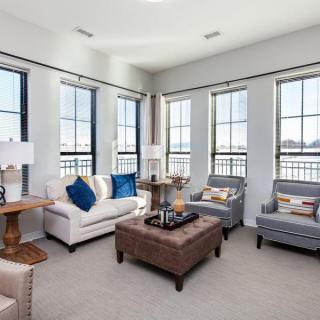 A modern living room with elegant furniture and large windows.