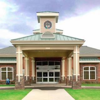 A modern architectural design featuring a clock tower and welcoming entrance.