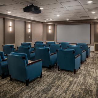 A modern home theater with comfortable seating and a large screen.