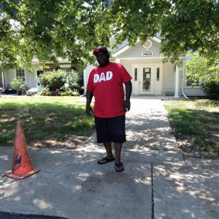 A proud dad enjoying a sunny day outdoors.