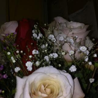 A beautiful bouquet featuring soft-colored roses and delicate filler flowers.