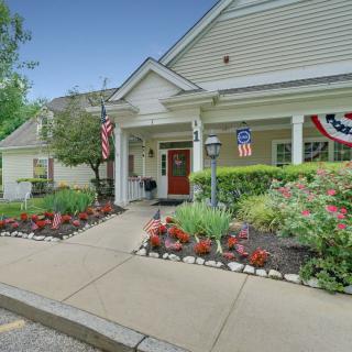 A welcoming building entrance adorned with flowers and patriotic decorations.