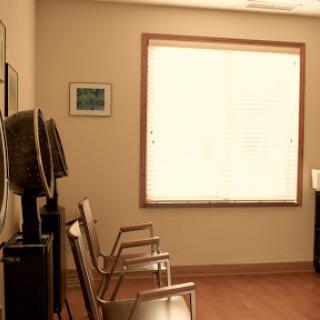 A serene waiting room with chairs and soft natural light filtering through the window.